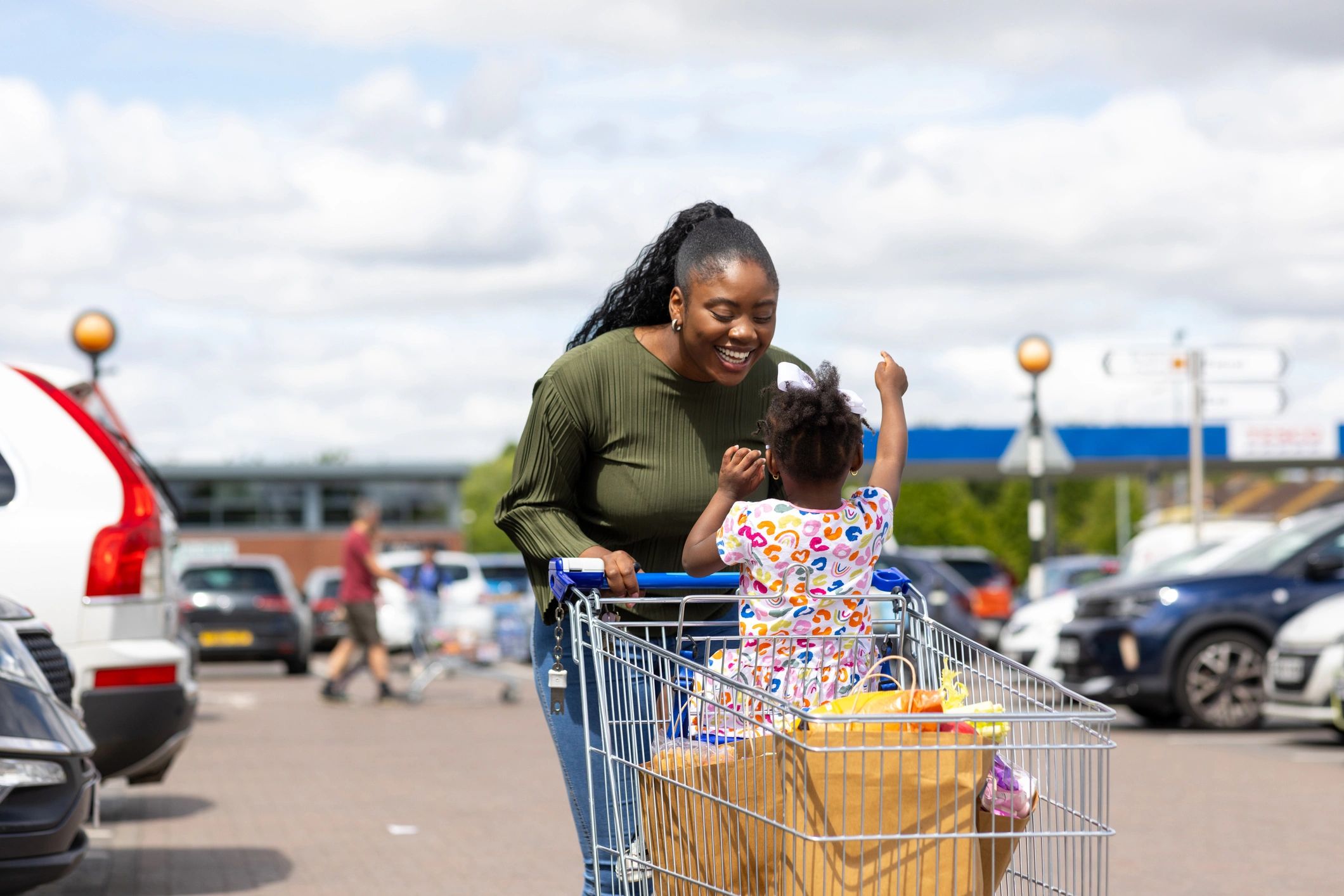 Mother and daughter shopping with a supermarket trolley
